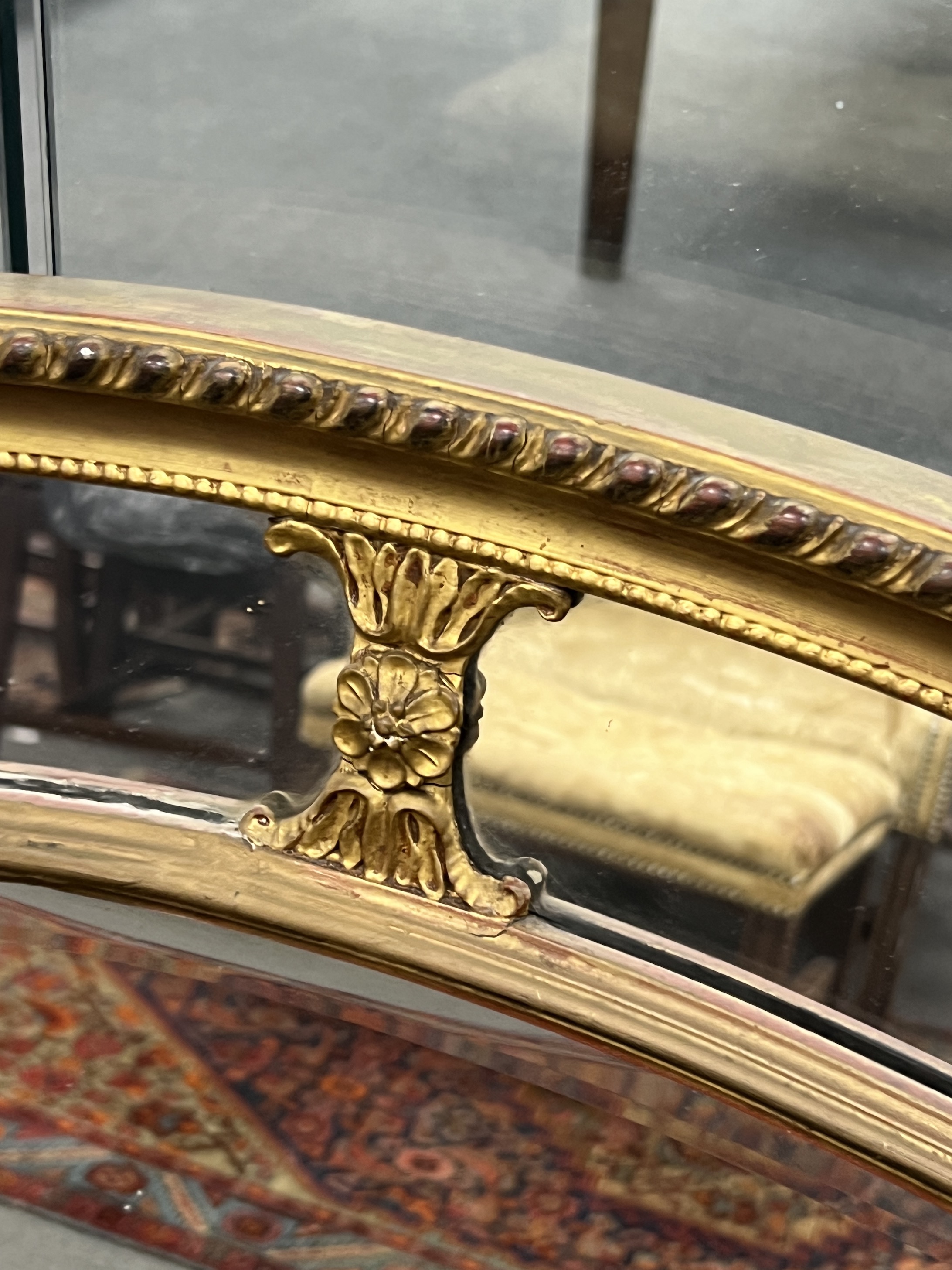 An oval giltwood and composition marginal plate wall mirror, width 113cm, height 83cm
